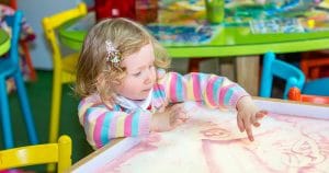 Little girl playing in sand